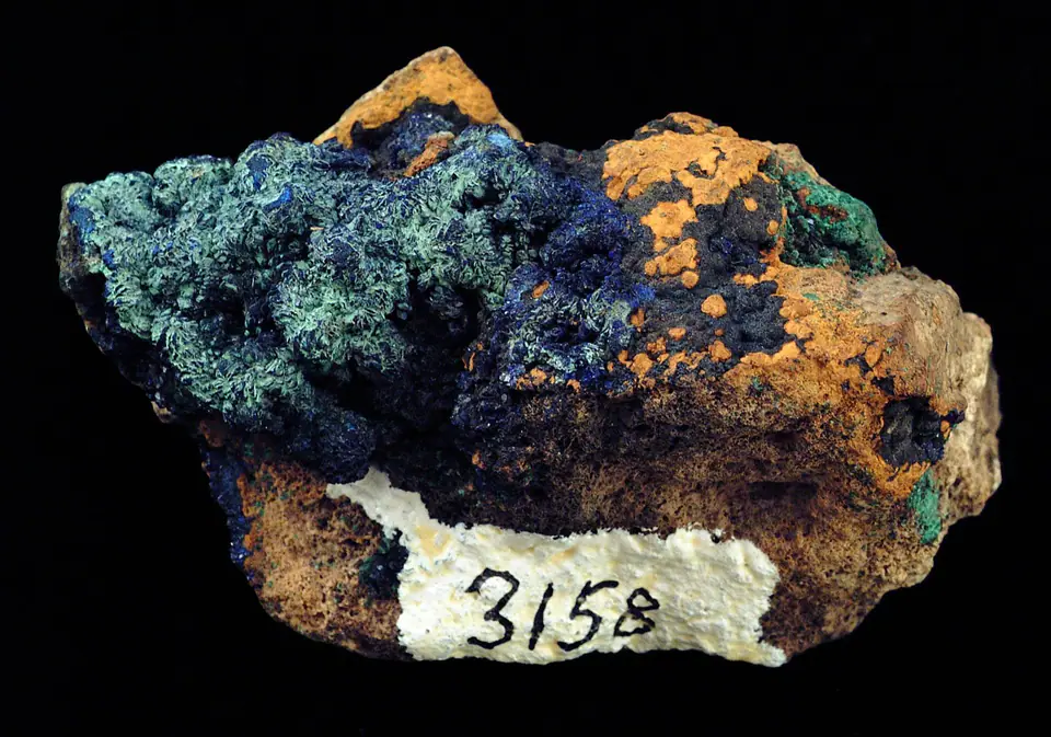 Dark blue azurite with green malachite and rusty orange limonite in an eight-centimeter specimen