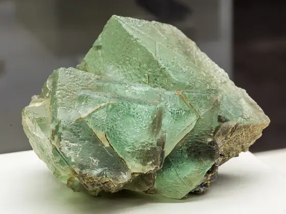 Pale green fluorite specimen with intergrown cubic and octahedral crystal faces