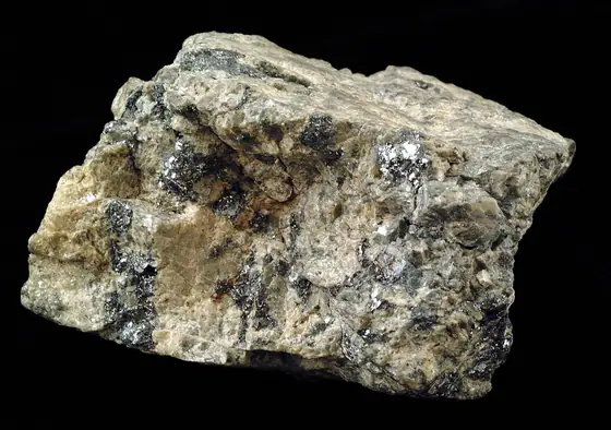 Bluish-silver molybdenite flakes along pale veins in a granite specimen