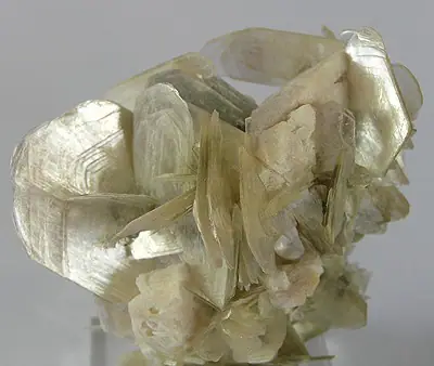 Muscovite mineral specimen with silvery sheet-like mica crystals on albite