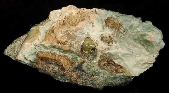 Yellow-green olivine crystal specimen in dark matrix
