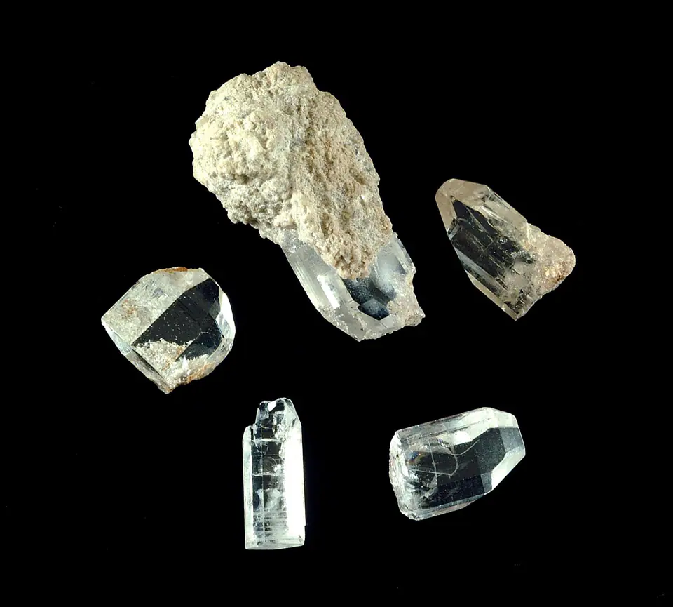 Clear topaz crystals partly attached to pale rhyolite from Topaz Mountain in Utah