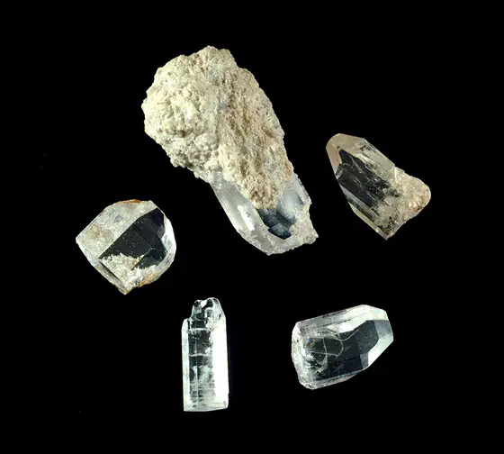 Clear topaz crystals partly attached to pale rhyolite from Topaz Mountain in Utah
