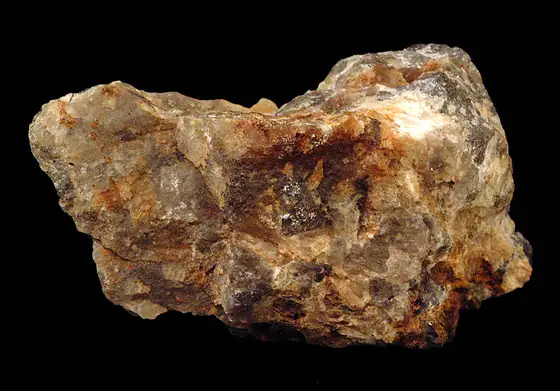 Brown zircon crystals embedded in a pale translucent mineral matrix
