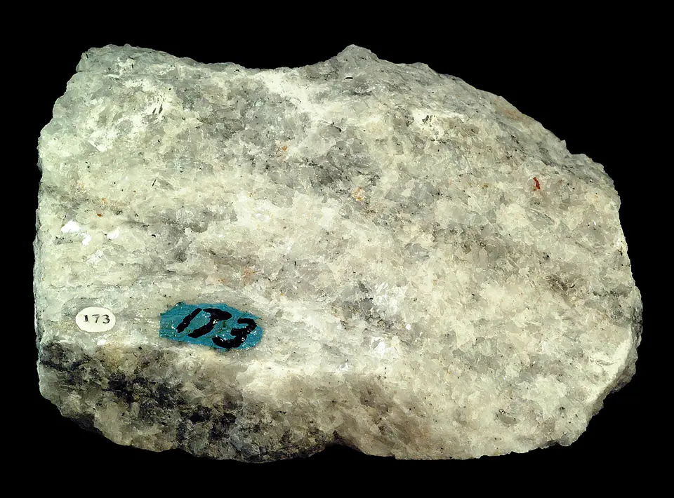 White and gray marble hand specimen with an interlocking crystalline texture