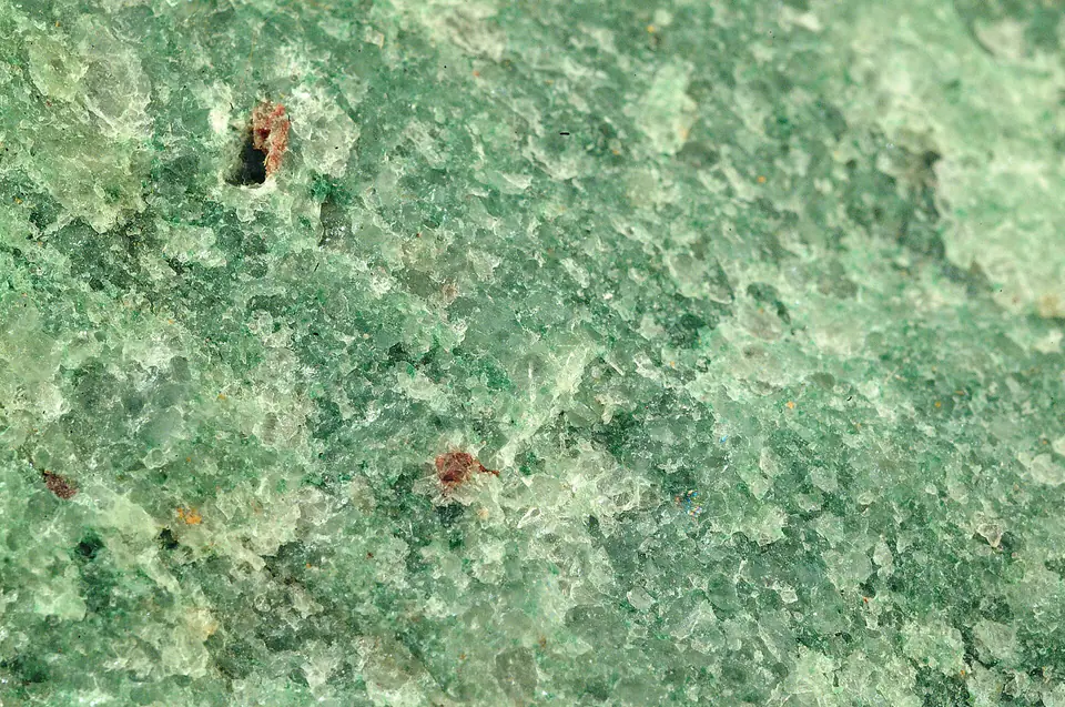 Light-colored quartzite hand specimen with a fused granular texture