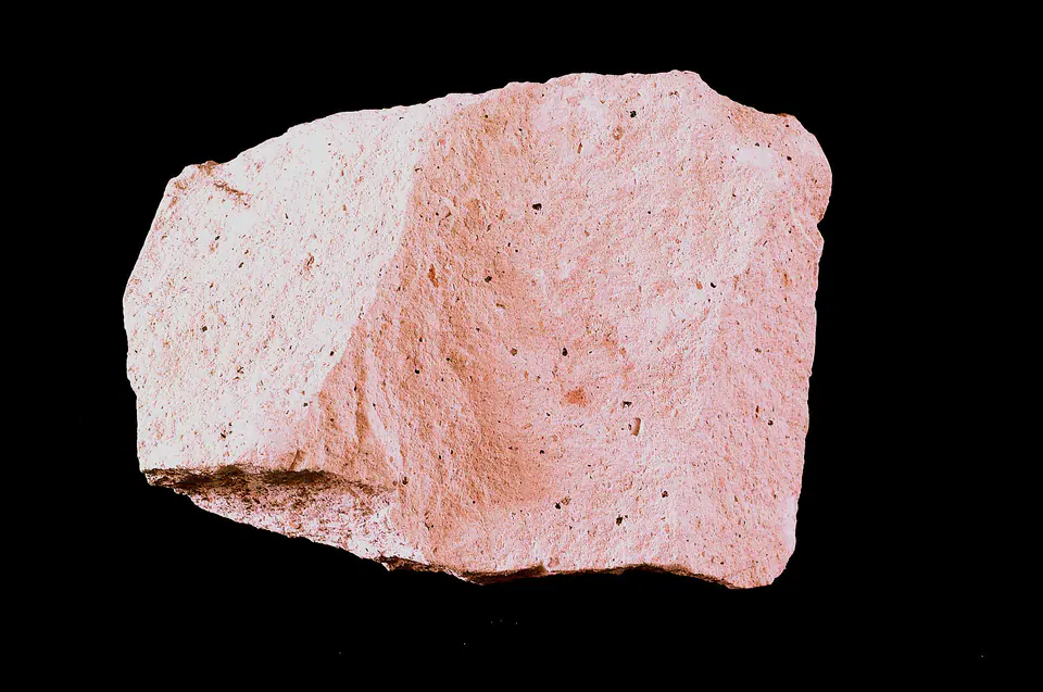 Light-colored rhyolite hand specimen with a fine-grained volcanic texture